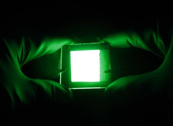 ATHENA LED light two gloved hands holding and LED green light