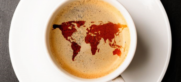 café avec une carte du monde dessinée dans la mousse du café